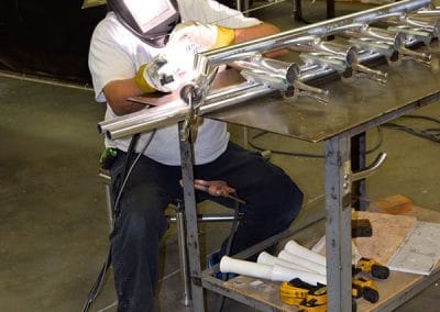 man welding 2 pipes